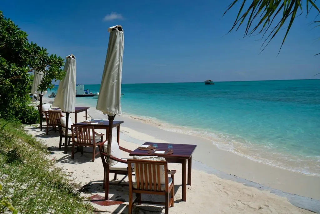 brown wooden chairs on beach during daytime